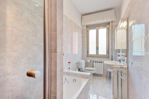 a bathroom with a tub and a sink and a toilet at Lerici sea view private parking best position in Lerici