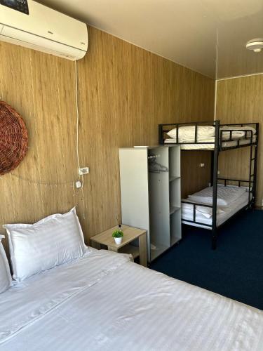 a bedroom with a bed and two bunk beds at Chorvoq View in Chorwoq