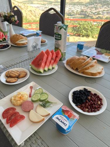 a table with plates of different types of food at Chorvoq View in Chorwoq