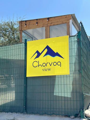 a sign on top of a fence at Chorvoq View in Chorwoq