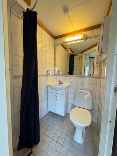 a bathroom with a toilet and a sink at Camp Skytterhuset in Hammerfest