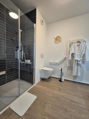 a bathroom with a shower and a toilet and a sink at Oh Activ Donville-Les-Bains - Résidence Services Seniors in Donville-les-Bains