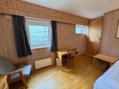 a room with a bed and a desk and a table at Camp Skytterhuset in Hammerfest