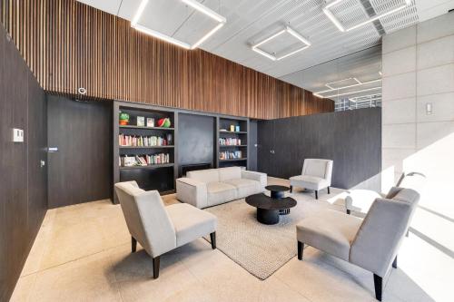 a living room with chairs and a couch and a table at Nest Apartments on Rose Lane in Melbourne