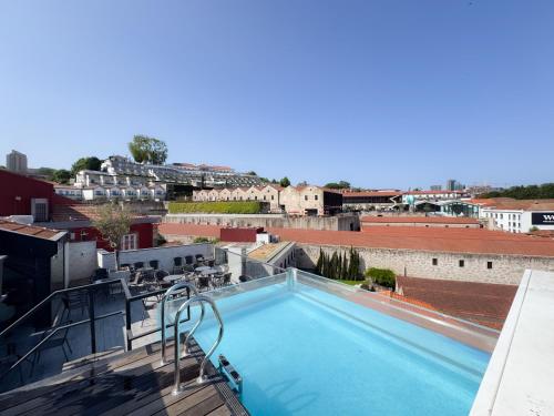 a swimming pool on the roof of a building at Smartr Porto Reis de Gaia & Spa in Vila Nova de Gaia