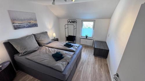 a small living room with a couch and a window at 24-7 Living - Unna Central City Apartments in Unna