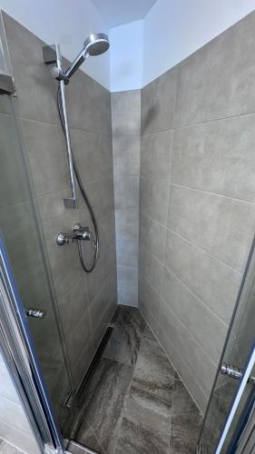 a bathroom with a shower with a glass door at 24-7 Living - Unna Central City Apartments in Unna