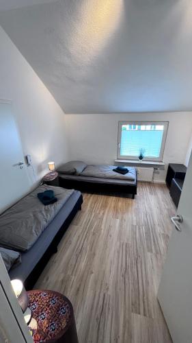 a bedroom with two beds and a window at 24-7 Living - Unna Central City Apartments in Unna