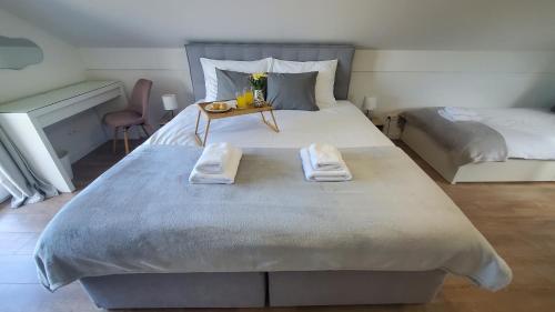a bedroom with a large bed with towels on it at Holiday home Vinovilla in Kutjevo