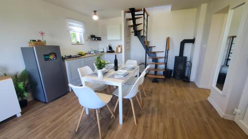 a kitchen and a dining room with a table and chairs at Holiday home Vinovilla in Kutjevo