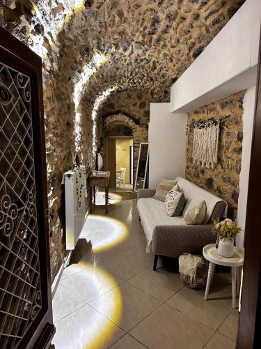 a living room with a couch and a stone wall at Mesta Diamond in Mesta