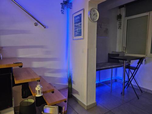a room with a table and a blue light at Pipo Apartment Mareda in Novigrad Istria