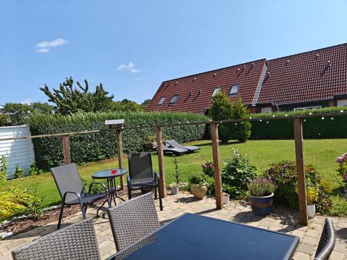 a patio with two chairs and a table and a table and chairs at Charming ROOM in a Cozy Home in Stege in Stege