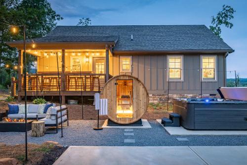 a house with a large wooden circle in front of it at Wellness Cabin - Sauna Cold Plunge Hot Tub Pool in Talking Rock
