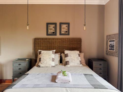 a bedroom with a large bed with two night stands at The Urn Guesthouse in Middelburg