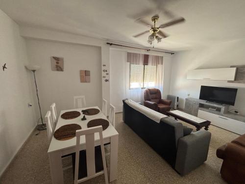 a living room with a couch and a table at La Cuesta House in Castell de Ferro