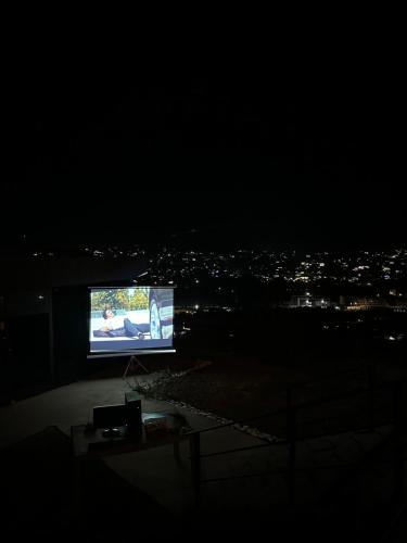 a flat screen tv on top of a building at night at Chorvoq View in Chorwoq