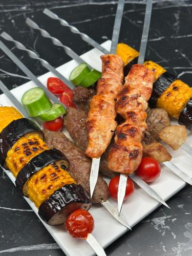 a plate of different types of food on a table at Chorvoq View in Chorwoq