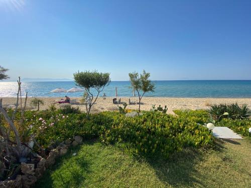 a beach with the ocean in the background at Azzure Heaven in Loutrá Elevtherón