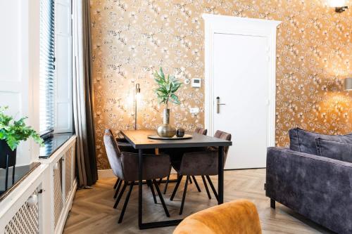 a dining room with a table and chairs at Stylish city center villa tilburg in Tilburg
