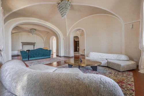 a living room with two couches and a table at Villa Leonardo - Vinci in Vinci
