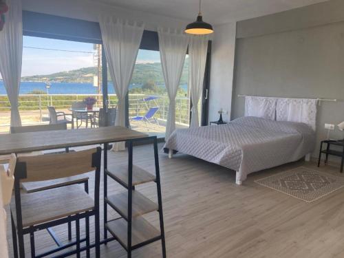 a bedroom with a bed and a table with a view at Maurizio's Villa in Yiáltra