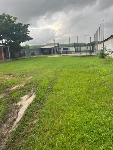 an empty soccer field with a fence in the distance at Chácara Ws in Maceió