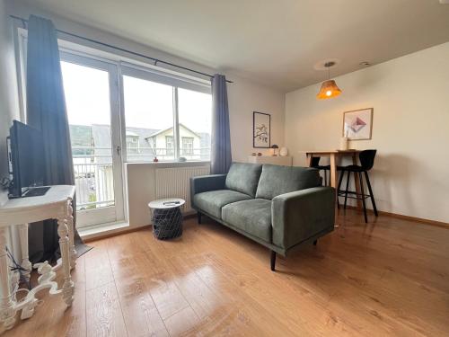 a living room with a couch and a table at LL Properties - The Downtown Nest in Akureyri