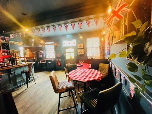 a restaurant with a table and chairs and a bar at horn and trumpet in Bewdley