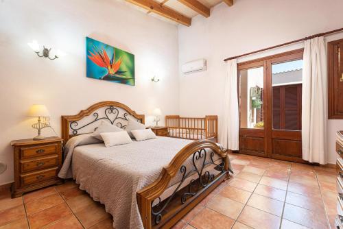 a bedroom with a large bed and a window at Finca Kelly in Artá