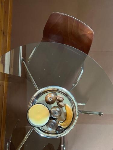 a pot on a glass table with some food on it at Chalet en bord d'étang in Longpré-les-Corps-Saints
