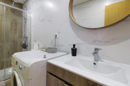 a white bathroom with a sink and a mirror at Al Do Paço - Between Braga e Geres in Amares