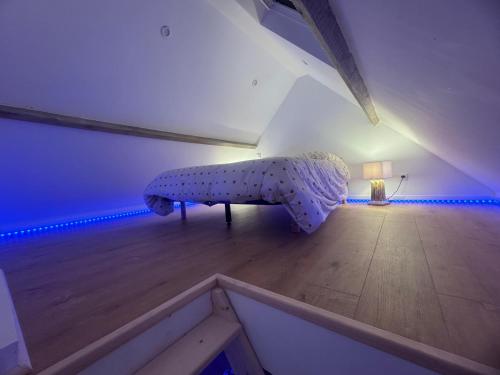an attic room with a bed in the attic at L'ouragan in Wimille