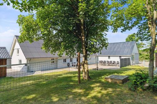 a white house with a fence and trees at 1055-Thisted-Lien-50 in Thisted