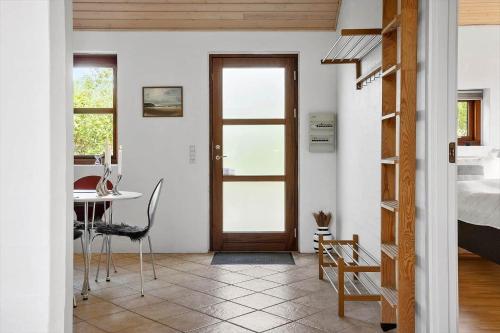 a room with a door and a table and a bed at 490-Snedsted-Niels-Juels-Vej-39 in Snedsted