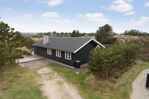 an aerial view of a black house on a hill at 930-Thisted-Liusborg-Sti-28 in Torsted