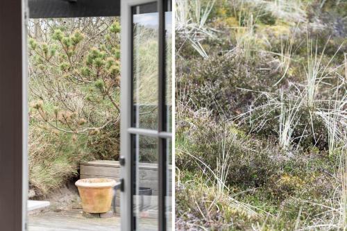 a glass door leading into a yard with a plant at 930-Thisted-Liusborg-Sti-28 in Torsted
