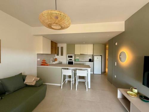 a living room and kitchen with a couch and a table at Diana Seaside Apartment in Anavissos