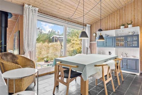 a kitchen and dining room with a table and chairs at 1030-Thisted-Lyngstien-15-A in Torsted