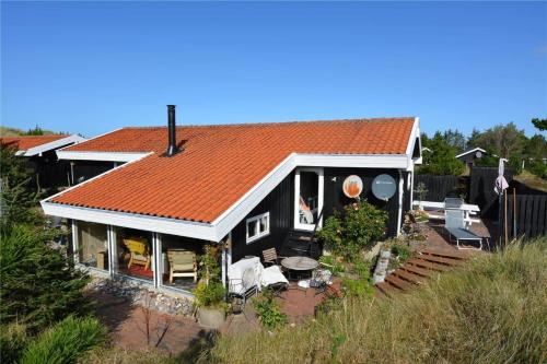a black house with an orange roof at 1030-Thisted-Lyngstien-15-A in Torsted