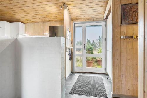 a hallway with a door leading to a kitchen at 1030-Thisted-Lyngstien-15-A in Torsted