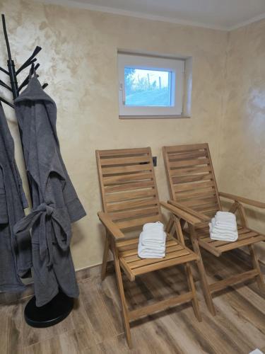 two chairs in a room with a window at Kuća za odmor Marinano in Slavonski Brod