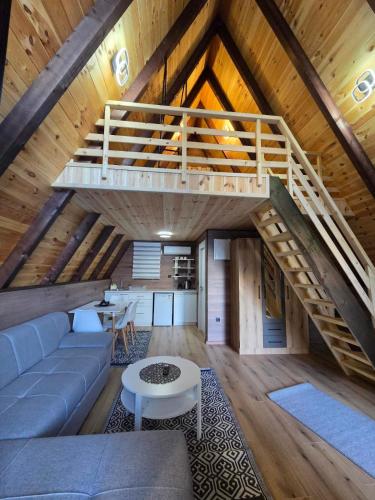 a living room with a couch and a staircase at Visitor Place in Plav
