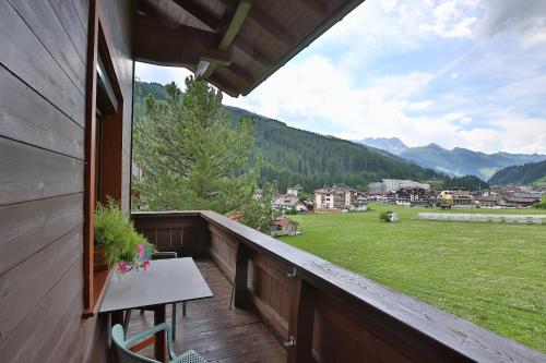 a balcony with a table and a view of a field at Haus Hildegard in Gerlos