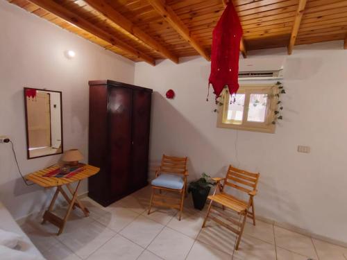 a room with two chairs and a table and a window at Light House studio in Dahab