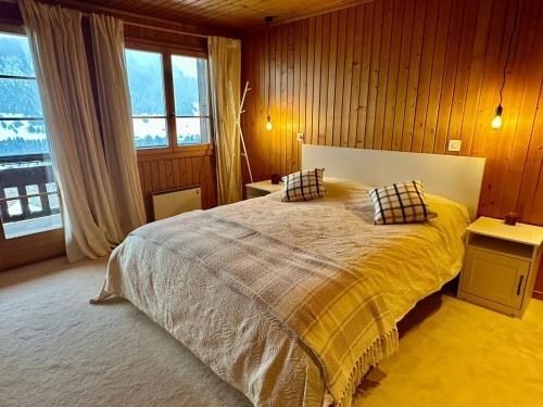 a bedroom with a bed with two pillows on it at Chalet Bliss with Spectacular Views in Chateau-d'Oex