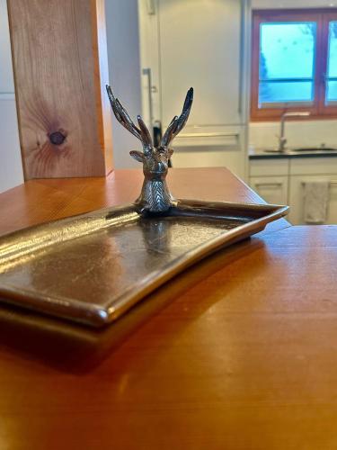 a metal tray sitting on top of a wooden table at Chalet Bliss with Spectacular Views in Chateau-d'Oex