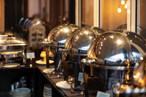 a row of silver domes sitting on a counter at Imperial Hotel in Copenhagen