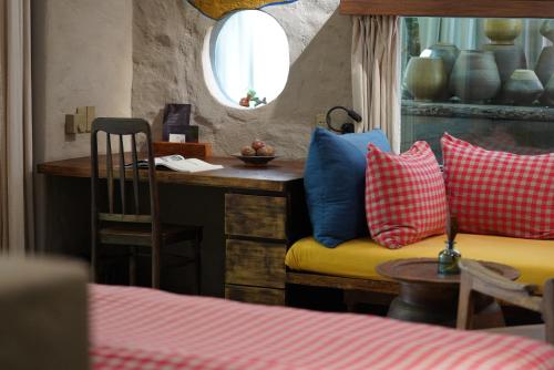 a room with a couch and a table with pillows at Dechiu in Hoi An