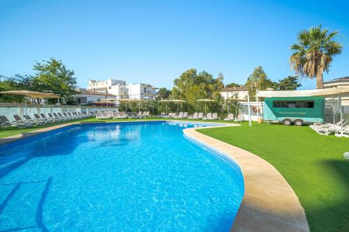 a swimming pool with chairs and a rv at a resort at THB Maria Isabel - Adults Only in Playa de Palma
